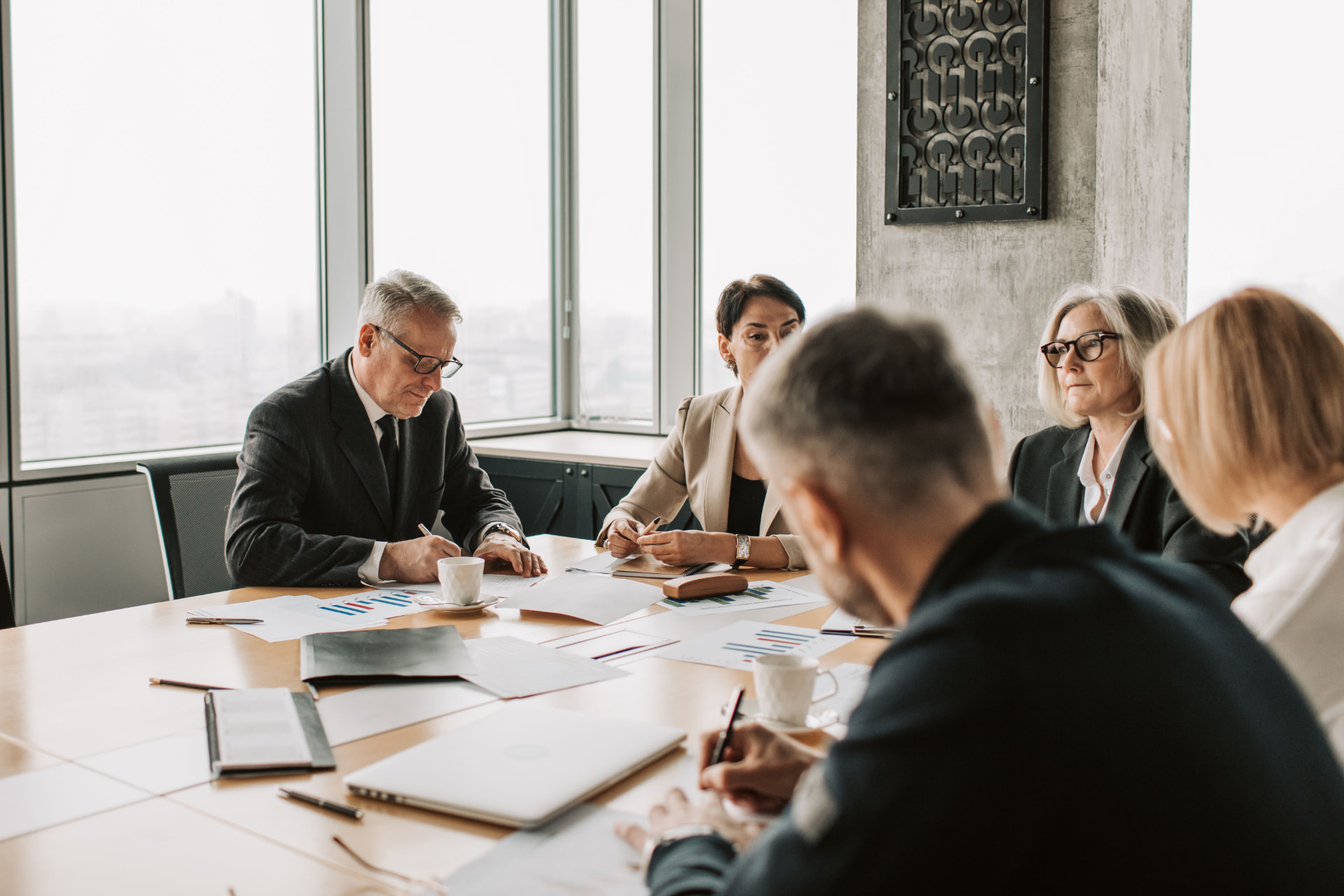 Business leaders reviewing financial information in a meeting